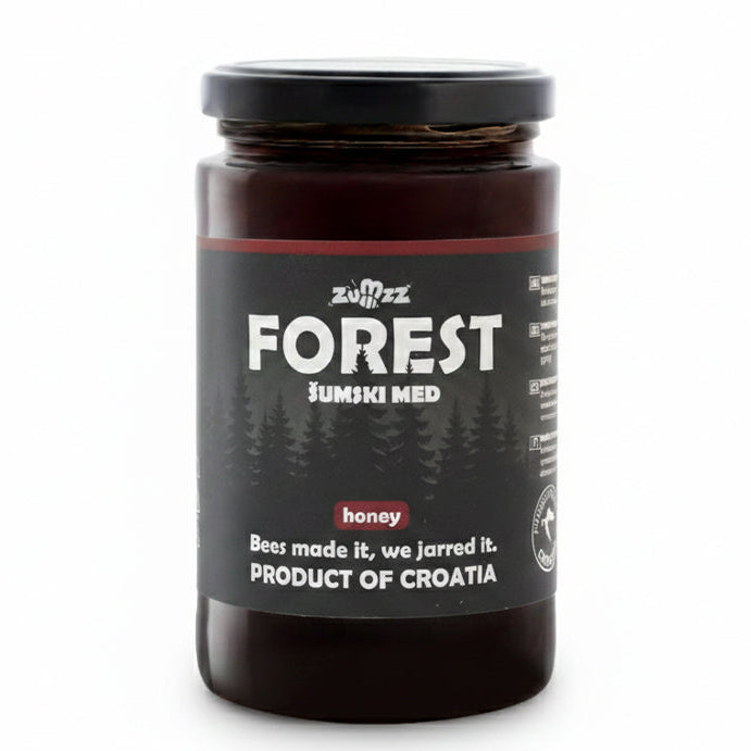 Jar of forest honey with a black label on a white background